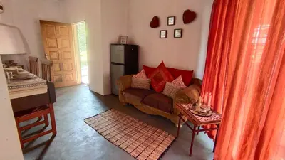 a living room with a couch and a refrigerator at Nomads Rest in Sterkspruit
