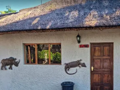 a house with a cow statues on the side of it at Rondevue Game Lodge in Warmbaths