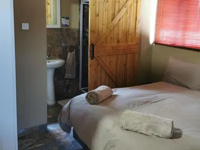a bedroom with a bed with a towel on it at Rondevue Game Lodge in Warmbaths
