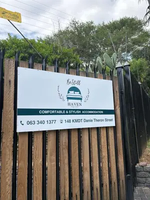 a sign on a wooden fence at Be Still Haven in Polokwane