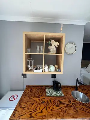 a kitchen with a wooden counter top and a sink at Be Still Haven in Polokwane