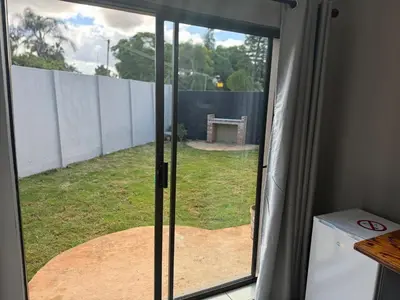 a sliding glass door with a view of a yard at Be Still Haven in Polokwane