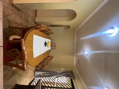 a room with a spiral staircase in a house at Windsor villa in Pretoria