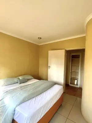 a bedroom with a large bed in a room at Windsor villa in Pretoria