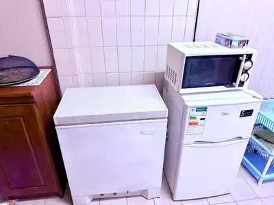 a microwave oven sitting on top of a refrigerator at El Roi apartment in Middelburg