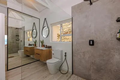 a bathroom with a toilet and a sink and a shower at Enso Botanico in Hartbeespoort