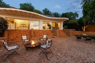 a patio with chairs and a fire pit at Enso Botanico in Hartbeespoort