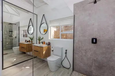 a bathroom with a toilet and a sink and a shower at Enso Botanico in Hartbeespoort