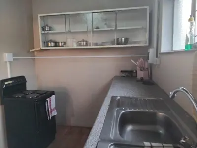 a kitchen with a sink and a counter top at Claremont Secured unit in Pretoria
