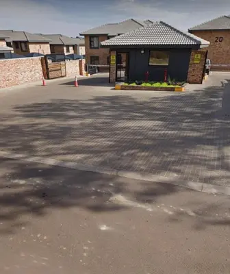 a parking lot in front of a building at Cloveridge 104 in Benoni