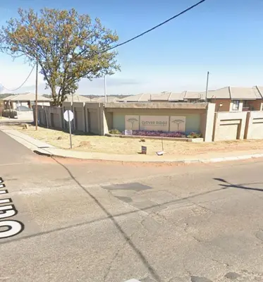 an empty street in front of a building at Cloveridge 104 in Benoni