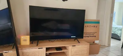 a large flat screen tv sitting on top of a box at Cloveridge 104 in Benoni