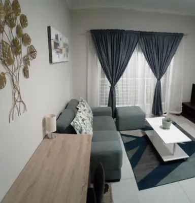 a living room with a couch and a table at Gorgeous Teres place in Midrand