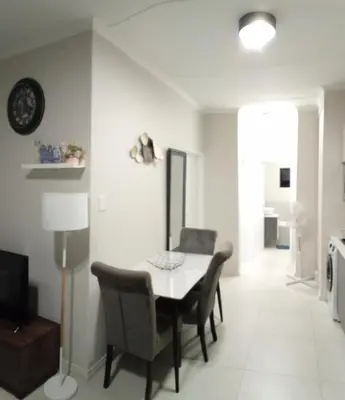 a dining room with a table and chairs at Gorgeous Teres place in Midrand