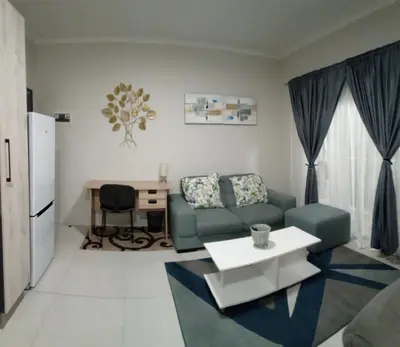 a living room with a couch and a table at Gorgeous Teres place in Midrand