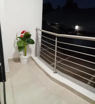 a plant on a balcony with a fence at Gorgeous Teres place in Midrand