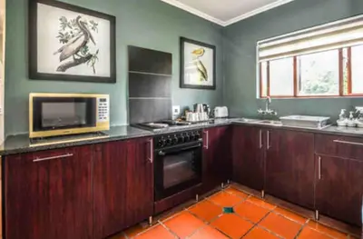 a kitchen with a stove and a microwave at Peace and Comfort - Greenway Woods in White River