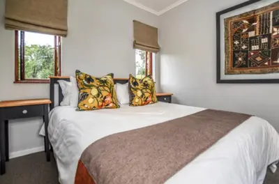 a bedroom with a large white bed with pillows at Peace and Comfort - Greenway Woods in White River