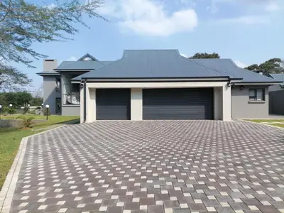 a house with a parking lot in front of it at Diamond and Pearl Holiday Home in Hazyview