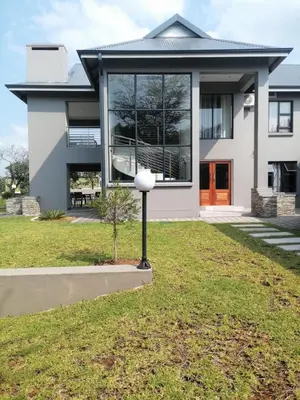 a house with a yard with a house at Diamond and Pearl Holiday Home in Hazyview