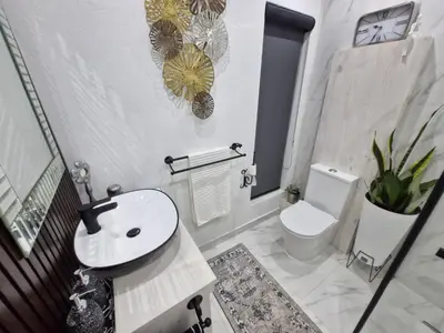 a bathroom with a white sink and a toilet at Indulge luxury overnight accommodation in Middelburg