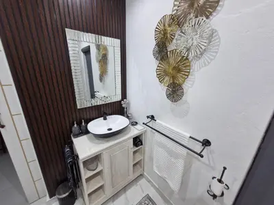 a bathroom with a sink and a mirror at Indulge luxury overnight accommodation in Middelburg