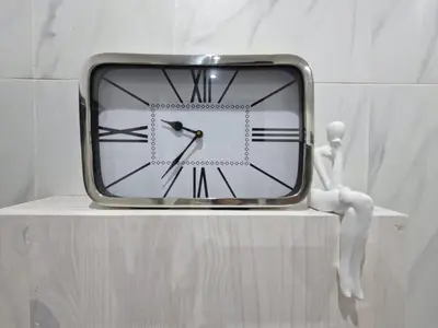 a clock sitting on top of a shelf with a doll at Indulge luxury overnight accommodation in Middelburg
