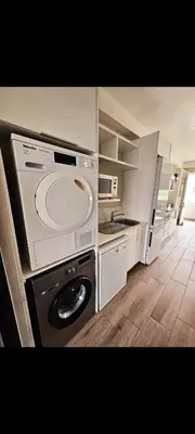 a kitchen with a washing machine and a washer at Romantic Victorian guest room in Pretoria