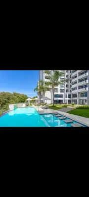a large swimming pool in front of a building at Romantic Victorian guest room in Pretoria