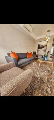 a living room with a couch and a table at Romantic Victorian guest room in Pretoria