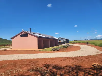 a building in the middle of a dirt field at Zondereinde Accommodation in Wag ʼn Bietjie Draai