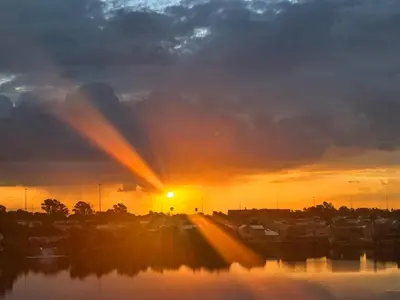 a sunset over a body of water with the sun setting at Your Perfect Escape with Breathtaking Lake Views in Pretoria