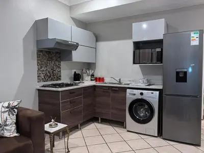 a kitchen with a washer and a dishwasher at Your Perfect Escape with Breathtaking Lake Views in Pretoria