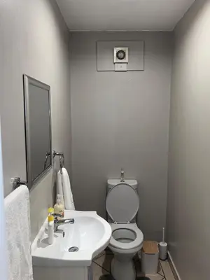 a white bathroom with a toilet and a sink at Your Perfect Escape with Breathtaking Lake Views in Pretoria
