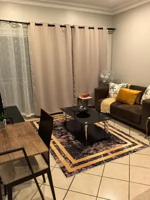 a living room with a couch and a table at Your Perfect Escape with Breathtaking Lake Views in Pretoria
