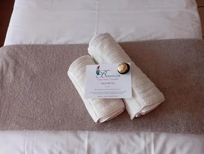 a towel on a bed with a sign on it at Bloemhoek Guest House in Centurion