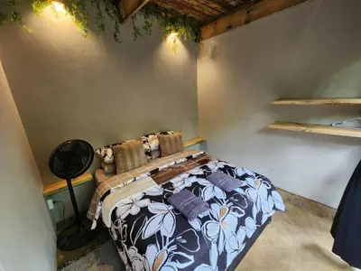 a bedroom with a bed in a room at Hartbeest Bush Stay #5 in Hartbeespoort