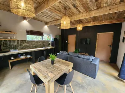 a living room with a table and a couch at Hartbeest Bush Stay #5 in Hartbeespoort
