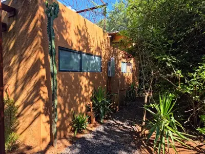 a building with a shadow on the side of it at Hartbeest Bush Stay #5 in Hartbeespoort