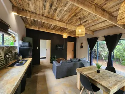 a living room with a table and a couch at Hartbeest Bush Stay #5 in Hartbeespoort