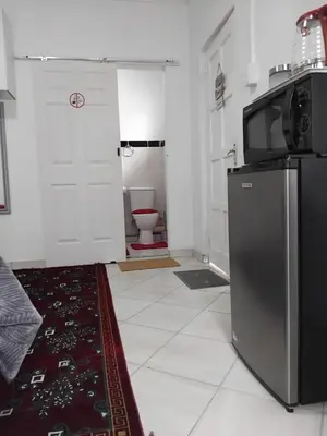 a kitchen with a refrigerator and a toilet at Claremont Secured Residence in Pretoria