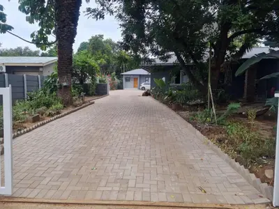 a brick driveway in front of a house at Shabi's Guest Lodge in Phalaborwa