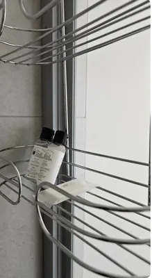 a glass shelf with two cell phones on it at The Sactuary in Midrand