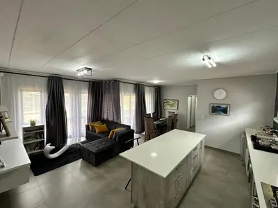 a living room with a couch and a table at MAYAMUYE Lifestyles in Nelspruit