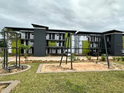 an apartment building with a playground in front of it at MAYAMUYE Lifestyles in Nelspruit