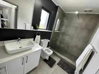 a bathroom with a sink and a shower and a toilet at MAYAMUYE Lifestyles in Nelspruit