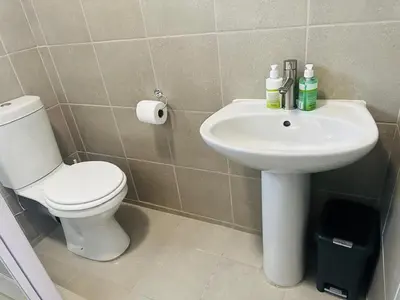 a bathroom with a toilet and a sink at Calm & Cozy Apartment in Pretoria