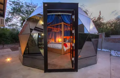 a tent with a bed inside of it at IHLATHi Glass Dome in Marloth Park