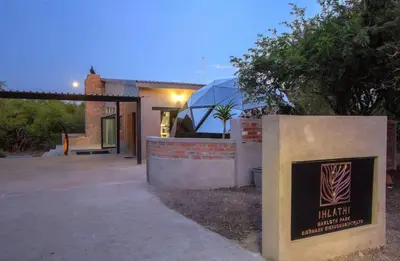 a house with a sign in front of it at IHLATHi Glass Dome in Marloth Park