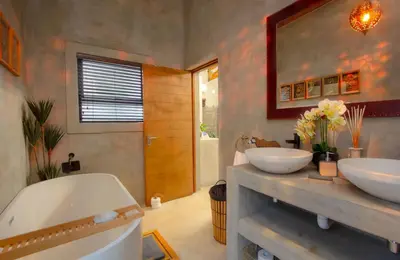 a bathroom with two sinks and a bath tub at IHLATHi Glass Dome in Marloth Park